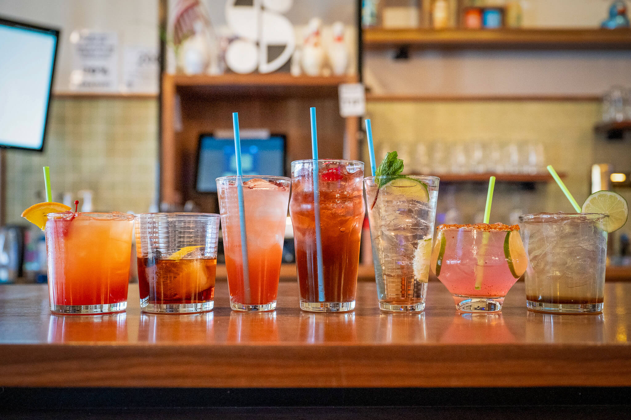 Multiple craft cocktails on the bar at Socibowl in Muskegon